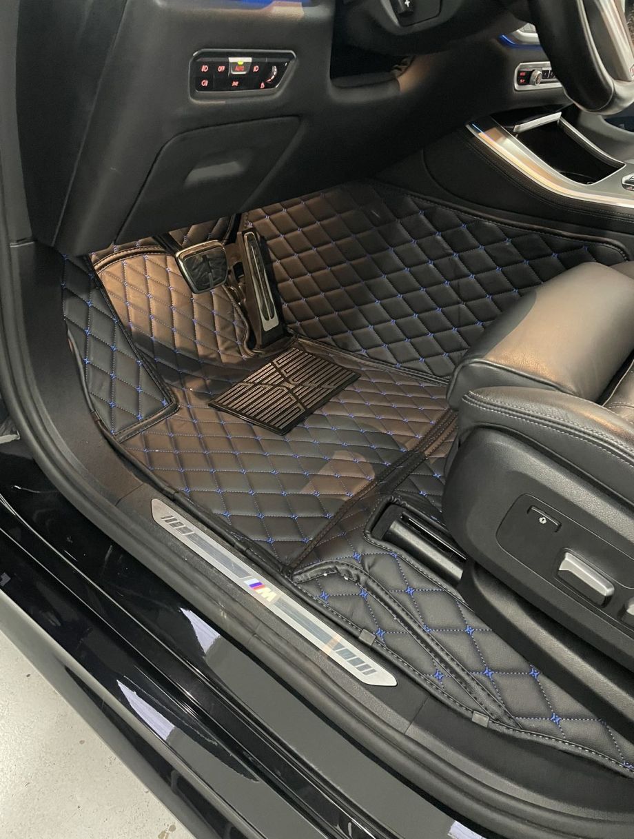 Young man vacuums the interior of a car